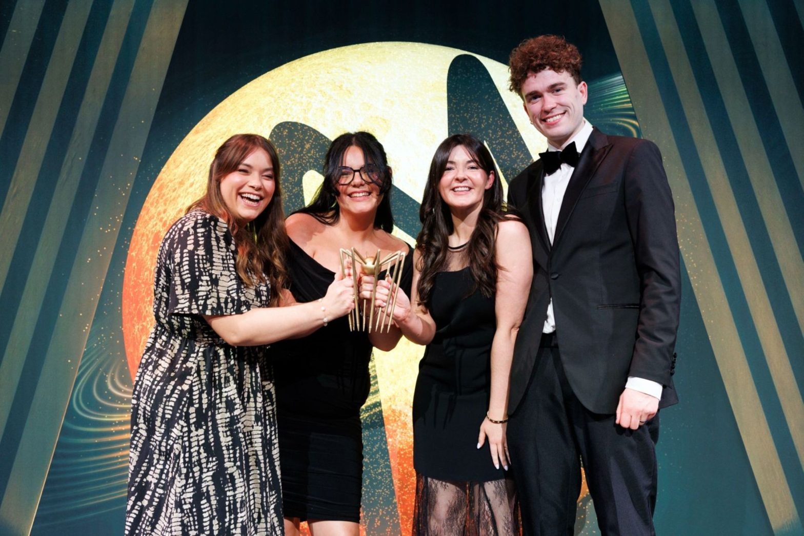 Representatives from BWG Foods, SPAR and EUROSPAR pictured at the Spider Awards 2026, where the “Breast Before Dates” campaign, delivered in partnership with the National Breast Cancer Research Institute, received the Best Influencer-Led Campaign Award. Pictured (L–R): Grainne Harrison, EUROSPAR Brand Manager, Zoe Lyons, SPAR Marketing Executive and Claire O'Brien, EUROSPAR Marketing Manager, received the award from Tom Gillan of Kooba.