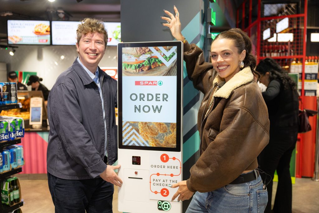 Michael Fry and Anna Clifford trying the ordering kiosk at SPAR KCR